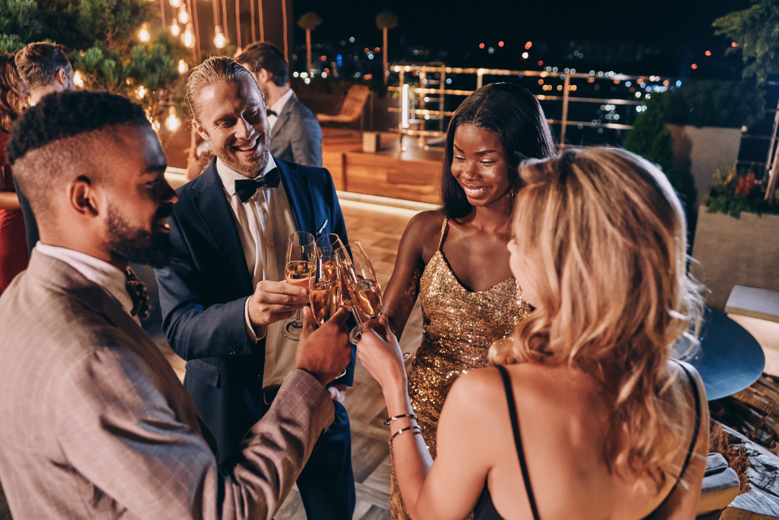Group of people in formalwear communicating and smiling while sp